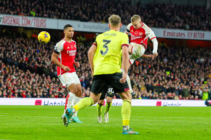 Oleksandr Zinchenko pictured (right) shooting in midair to score a spectacular goal for Arsenal in a 3-1 win over Burnley in November 2023